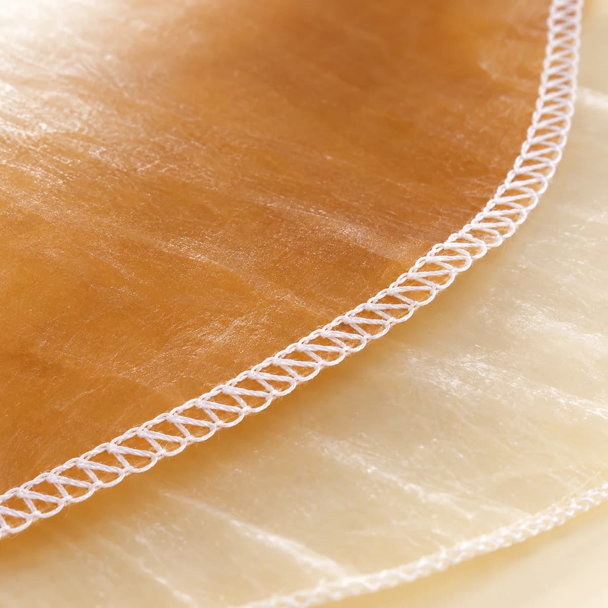 Close view of the stitched edge of an amber casing