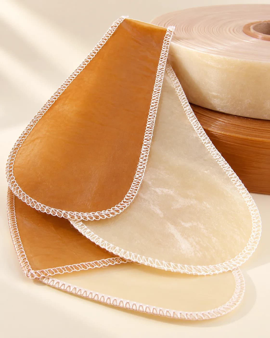 Amber and ivory sewn casings arranged with rolls of casing material